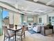 Inviting living room with tile floors, tray ceiling, balcony access and comfortable seating at 11 San Marco St # 807, Clearwater Beach, FL 33767