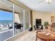 Bright living room with ocean view and sliding glass doors leading to a spacious balcony with outdoor dining at 11 San Marco St # 807, Clearwater Beach, FL 33767