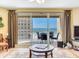 Comfortable living room with a sliding glass door to a balcony with ocean views at 11 San Marco St # 807, Clearwater Beach, FL 33767