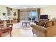 Comfortable living room with chairs and a couch near a balcony that overlooks the ocean at 11 San Marco St # 807, Clearwater Beach, FL 33767