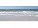 A sunny day at the beach features gentle waves and a serene horizon at 11 San Marco St # 807, Clearwater Beach, FL 33767