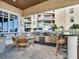This spacious outdoor kitchen has a grill, sink, seating, and dining table at 11 San Marco St # 807, Clearwater Beach, FL 33767