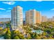 Breathtaking aerial image of condos, lush landscaping, inviting pools, and serene waterfront views, ideal for luxury living at 1170 Gulf Blvd # 2001, Clearwater, FL 33767