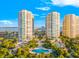 Aerial view of the luxurious towers with pools, palm trees, and pristine landscaping at 1170 Gulf Blvd # 2001, Clearwater, FL 33767
