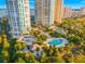 Aerial view showcasing stunning condo buildings with access to multiple pools, lush landscaping, and serene waterfront views at 1170 Gulf Blvd # 2001, Clearwater, FL 33767