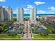 Beautiful aerial view of beachfront condos, tennis courts, and well-manicured landscaping on a sunny day at 1170 Gulf Blvd # 2001, Clearwater, FL 33767