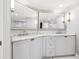 A luxurious bathroom with double sinks, marble countertops, and custom cabinets at 1170 Gulf Blvd # 2001, Clearwater, FL 33767