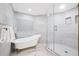 This stylish bathroom features a freestanding tub, glass-enclosed shower, and elegant marble finishes at 1170 Gulf Blvd # 2001, Clearwater, FL 33767