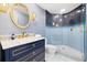 Luxurious bathroom featuring a blue ombre tile glass enclosed shower and a blue vanity with gold hardware at 1170 Gulf Blvd # 2001, Clearwater, FL 33767