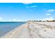 Expansive beach view showcasing pristine sands and clear blue waters meeting under a sunny sky at 1170 Gulf Blvd # 2001, Clearwater, FL 33767