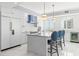 White kitchen with central island, stainless steel appliances and bar seating for casual meals at 1170 Gulf Blvd # 2001, Clearwater, FL 33767