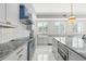 Stunning kitchen featuring marble countertops, stainless steel appliances, and custom range hood at 1170 Gulf Blvd # 2001, Clearwater, FL 33767