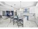 Open kitchen with marble countertops and backsplash, island with seating, luxury appliances, and views to the outside at 1170 Gulf Blvd # 2001, Clearwater, FL 33767