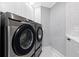 Modern stainless steel Samsung washer and dryer in a well-lit laundry area with white marble and white herringbone backsplash at 1170 Gulf Blvd # 2001, Clearwater, FL 33767