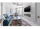 Comfortable living room with modern fireplace, stylish furniture, and a ceiling fan at 1170 Gulf Blvd # 2001, Clearwater, FL 33767