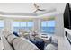 Airy living room with fireplace, tray ceilings, and ocean views from the balcony access at 1170 Gulf Blvd # 2001, Clearwater, FL 33767