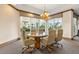 Conference area offers a round table with six chairs under a stylish chandelier by large windows at 1170 Gulf Blvd # 2001, Clearwater, FL 33767