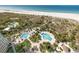 Aerial view of the beautifully landscaped pool area with easy beach access at 1170 Gulf Blvd # 2001, Clearwater, FL 33767