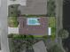 Aerial view showcasing the home's screened pool and outdoor living space in a serene setting at 12333 Woodlands Cir, Dade City, FL 33525