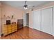 Bedroom with hardwood floors, ceiling fan, and spacious closet at 12333 Woodlands Cir, Dade City, FL 33525