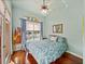This bedroom showcases hardwood floors, large window, and comfortable furniture at 12333 Woodlands Cir, Dade City, FL 33525