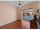 Bedroom with ceiling fan, hardwood floors, and sliding glass doors that lead to an outdoor pool at 12333 Woodlands Cir, Dade City, FL 33525