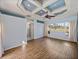 Bedroom boasts wood floors, neutral walls, bright windows and a unique tray ceiling design at 12333 Woodlands Cir, Dade City, FL 33525