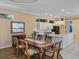 A formal dining room with a kitchen that has white countertops and cabinets at 12333 Woodlands Cir, Dade City, FL 33525