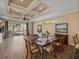 Dining room with table set, view of the screened lanai, and decorative ceiling at 12333 Woodlands Cir, Dade City, FL 33525