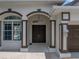Welcoming front entry featuring double doors, and decorative accents that offer curb appeal at 12333 Woodlands Cir, Dade City, FL 33525