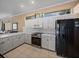 Kitchen with white countertops and cabinets, alongside black stainless steel appliances at 12333 Woodlands Cir, Dade City, FL 33525