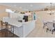 Bright kitchen features white cabinets, a breakfast bar, and stainless steel appliances at 12333 Woodlands Cir, Dade City, FL 33525