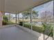 Screened lanai offering views of the lawn and pond at 12333 Woodlands Cir, Dade City, FL 33525