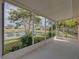 Enclosed lanai with a water view of the pond and landscaping at 12333 Woodlands Cir, Dade City, FL 33525