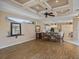 Open-concept living room and dining area featuring wood-look floors and decorative ceiling at 12333 Woodlands Cir, Dade City, FL 33525