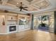 Spacious living room with fireplace, built-ins, and outdoor views at 12333 Woodlands Cir, Dade City, FL 33525