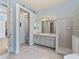The bathroom boasts a double sink vanity, a walk-in shower and a unique glass block window at 12333 Woodlands Cir, Dade City, FL 33525
