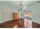 A bedroom boasts wood floors, ceiling fan, and sliding glass doors to the pool at 12333 Woodlands Cir, Dade City, FL 33525