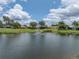 Scenic view of pond with fountain and manicured lawn at 12333 Woodlands Cir, Dade City, FL 33525
