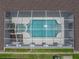 Overhead view of a screened pool with an attached jacuzzi, providing a private outdoor retreat at 12333 Woodlands Cir, Dade City, FL 33525