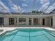Expansive screened-in pool area with multiple access points, great for entertaining and enjoying outdoor living at 12333 Woodlands Cir, Dade City, FL 33525
