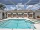Beautiful screened-in pool with a spa and unique column details creating a luxurious backyard retreat at 12333 Woodlands Cir, Dade City, FL 33525