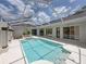Inviting screened-in pool with a jacuzzi, surrounded by a spacious patio area for outdoor enjoyment at 12333 Woodlands Cir, Dade City, FL 33525