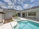 Inviting screened-in pool with spa and lush landscaping creating a serene and private backyard oasis at 12333 Woodlands Cir, Dade City, FL 33525