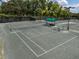 A series of tennis courts under a partly cloudy sky at 12333 Woodlands Cir, Dade City, FL 33525
