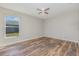 This bedroom offers a ceiling fan, wood flooring, and a window for natural light at 1308 22Nd E St, Palmetto, FL 34221