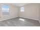 A light filled bedroom has a large window, wood look flooring, and neutral colored walls at 1308 22Nd E St, Palmetto, FL 34221