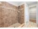 This remodeled bathroom features a tiled shower, a door to a walk-in closet, and neutral tile floors at 1308 22Nd E St, Palmetto, FL 34221