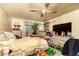 Cozy bedroom with a ceiling fan, a bedside table and a large window at 13225 101St St # 462, Largo, FL 33773