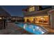 Gorgeous night view of the backyard pool, jacuzzi, and the living areas with large glass doors at 1336 51St Ne Ave, St Petersburg, FL 33703